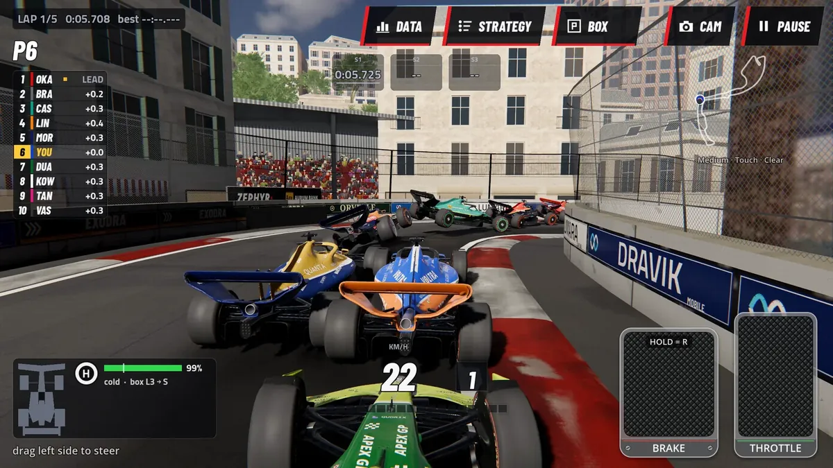 Apex GP gameplay: an orange and blue open-wheel car side by side with a rival through a street circuit lined with buildings and barriers